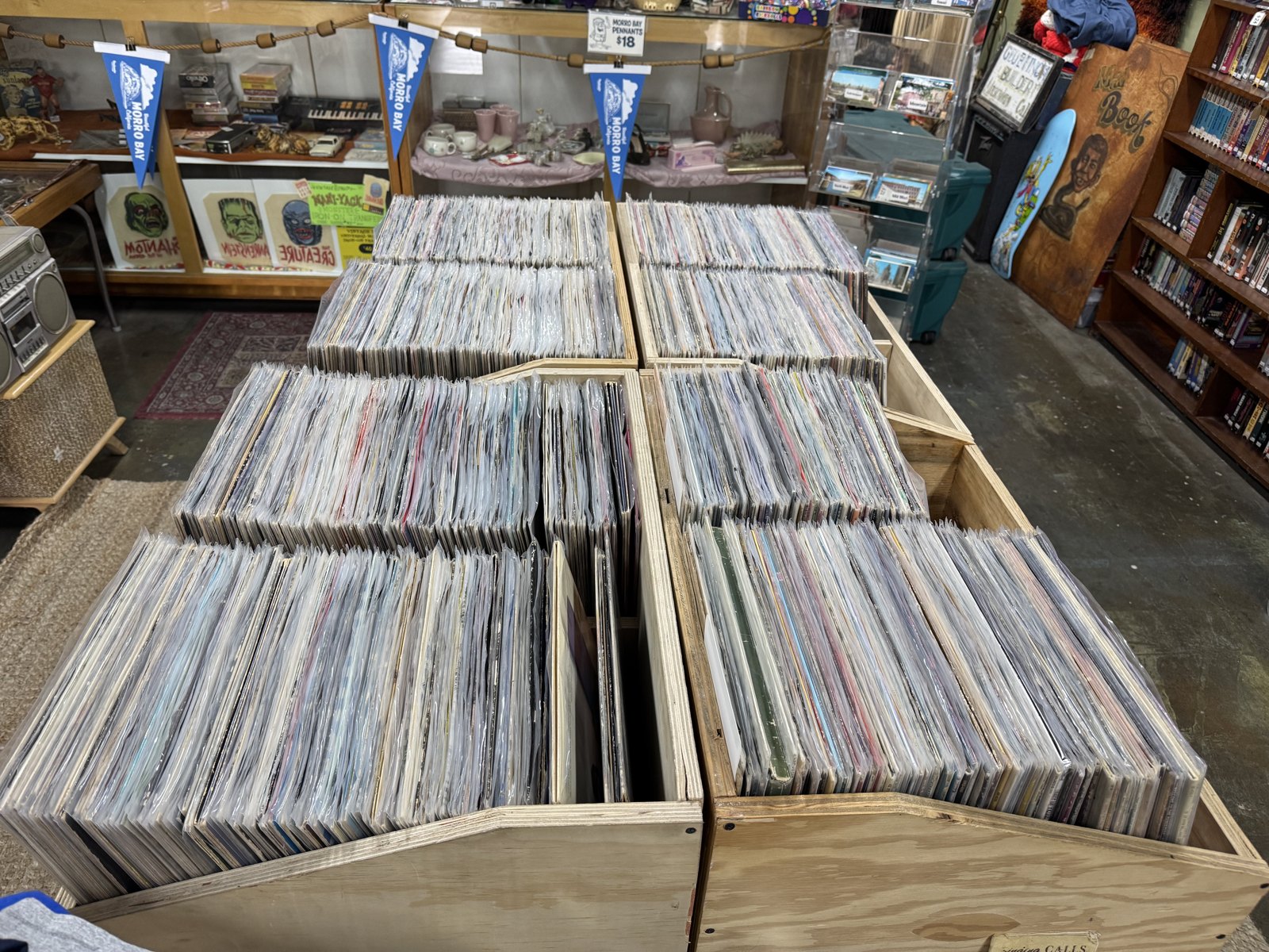 Wooden vinyl record bins and collectibles inside Beachcomber Vintage