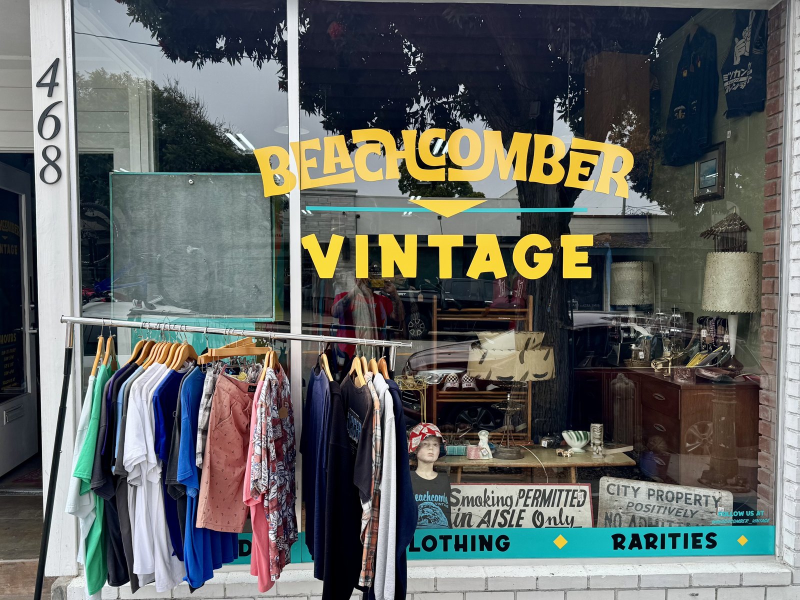 Beachcomber Vintage’s yellow window lettering and clothing rack at 468 Morro Bay Boulevard